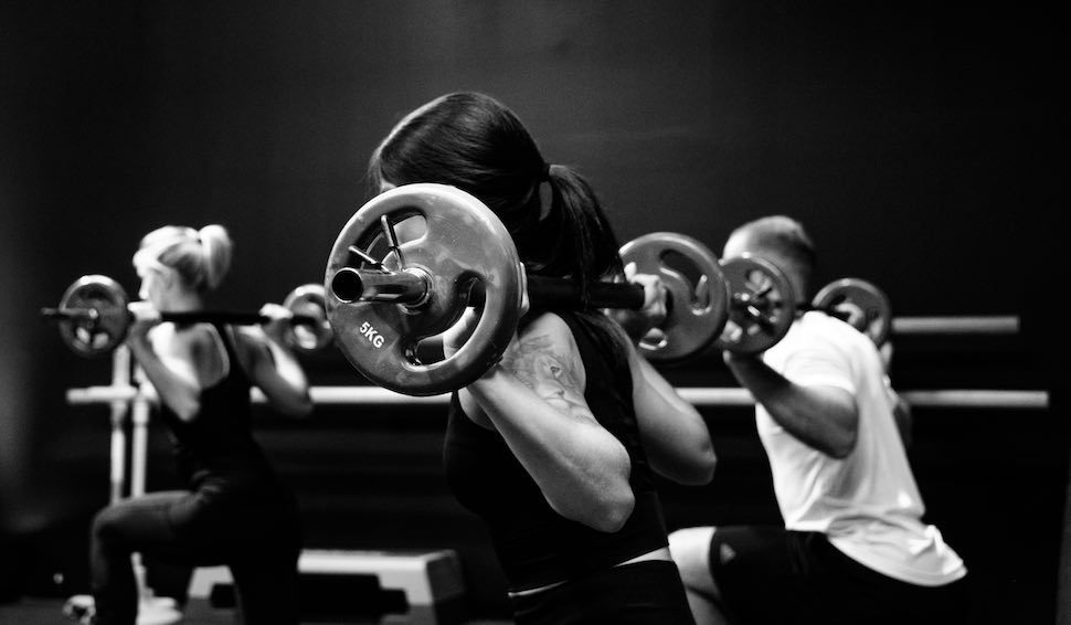 Three people lifting weights